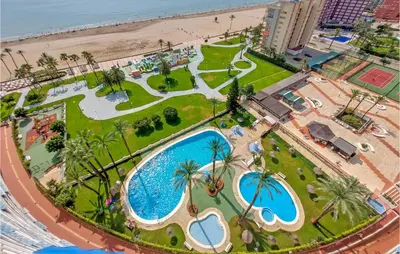 an overhead view of a resort with a pool and a beach at 1 Bedroom Nice Apartment In Cullera in Cullera