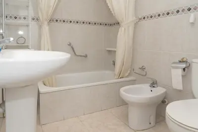 a bathroom with a sink and a tub and a toilet at Solimar, 4-8 in Cullera