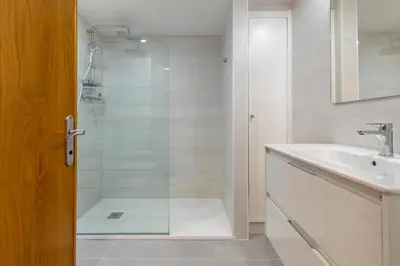 a bathroom with a shower and a sink at ApartUP Patacona Surfing Beach in Valencia