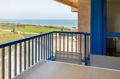 a balcony with a bench and a view of the ocean at ApartUP Patacona Surfing Beach in Valencia