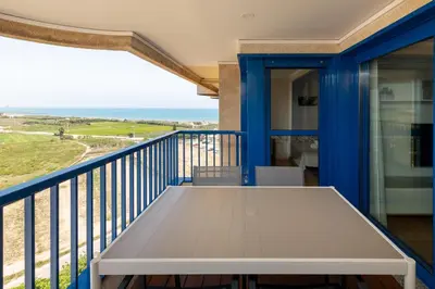 a balcony with a table and a view of the ocean at ApartUP Patacona Surfing Beach in Valencia