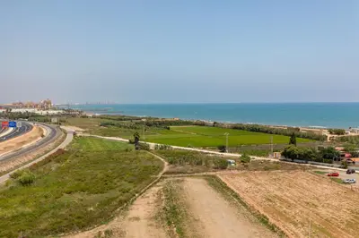 an aerial view of a road next to the ocean at ApartUP Patacona Surfing Beach in Valencia