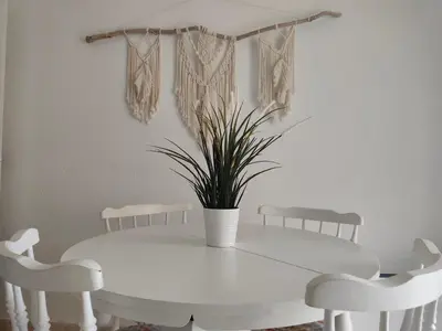 a white table with chairs and a potted plant at El Cisne frente al mar- Piscina y Wifi in Cullera