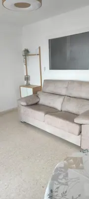 a living room with a couch in a room at El Cisne frente al mar- Piscina y Wifi in Cullera