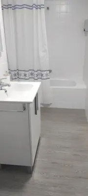 a bathroom with a white sink and a shower at El Cisne frente al mar- Piscina y Wifi in Cullera