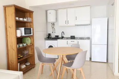 a bedroom with a white bed and a ceiling fan at Beautiful apartment in Canet Playa by Hometels in Canet de Berenguer