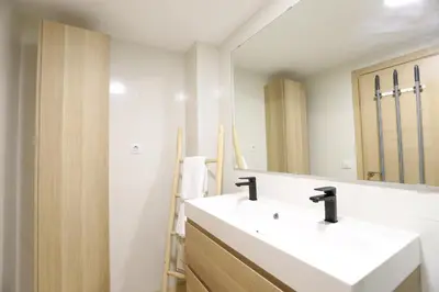 a bathroom with a toilet and a glass shower at Beautiful apartment in Canet Playa by Hometels in Canet de Berenguer