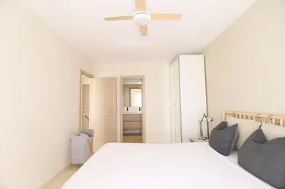 a bedroom with a bed with a lamp and pillows at Beautiful apartment in Canet Playa by Hometels in Canet de Berenguer