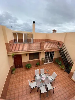 a patio with a table and chairs in front of a house at Casa Rural Roa in Casinos