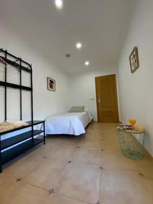 a bedroom with a bed and a tiled floor at Casa Rural Roa in Casinos