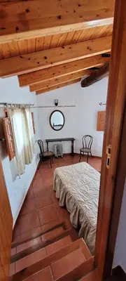 a bedroom with a bed and a wooden ceiling at Candela de la Murtera in Chelva