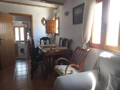 a living room with a table and a dining room at Candela de la Murtera in Chelva