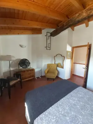 a bedroom with a bed and a chair and a desk at Candela de la Murtera in Chelva