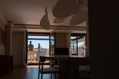 a man and woman standing on the balcony of a house at SingularStays Ático Reina Catalina in Valencia