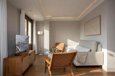 a living room with a television and a couch at SingularStays Ático Reina Catalina in Valencia