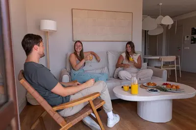 a group of people sitting on a couch in a living room at SingularStays Ático Reina Catalina in Valencia