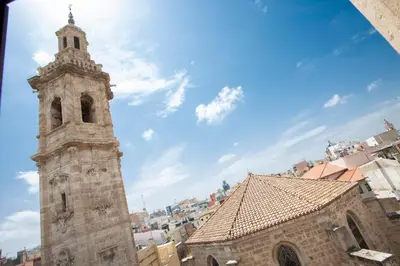 a tall building with a clock tower in a city at SingularStays Ático Reina Catalina in Valencia