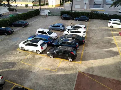 a group of cars parked in a parking lot at Cullera apartamento junto al mar in Cullera