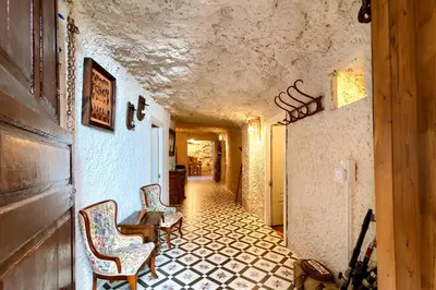 a hallway with two chairs and a table in a building at Cueva con jacuzzi a 20 minutos de Valencia in Benaguacil