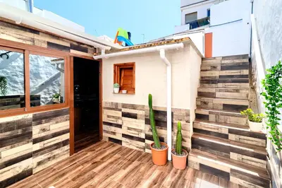 a house with wooden floors and potted plants at Cueva con jacuzzi a 20 minutos de Valencia in Benaguacil