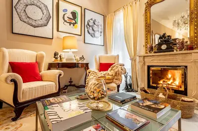 a living room with a fireplace and a table at Casa para familias y grupos in Manises