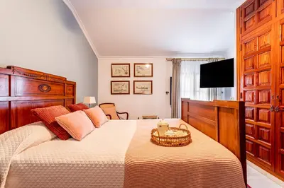 a bedroom with a large bed and a television at Casa para familias y grupos in Manises