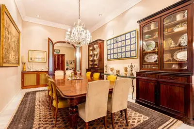 a dining room with a table and chairs and a chandelier at Casa para familias y grupos in Manises