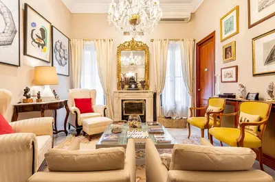 a living room with a fireplace and a chandelier at Casa para familias y grupos in Manises