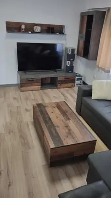 a living room with a flat screen tv and a coffee table at Apartamento Horizonte Azul Cullera in Cullera