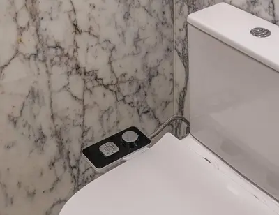 a white toilet in a bathroom with a counter at Luxury loft on the beach in Valencia