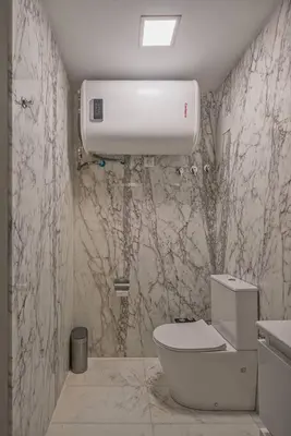 a bathroom with a toilet and a water tank at Luxury loft on the beach in Valencia