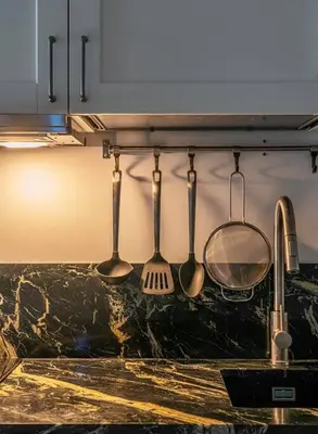 a group of kitchen utensils hanging from a wall at Luxury loft on the beach in Valencia