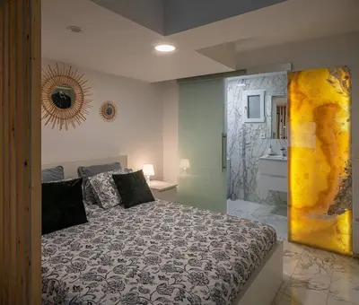 a bedroom with a large bed and a bathroom at Luxury loft on the beach in Valencia