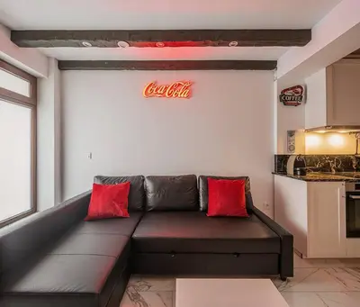 a couch in a room with a cocacola sign on the wall at Luxury loft on the beach in Valencia