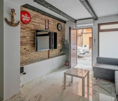 a living room with a brick wall and a table at Luxury loft on the beach in Valencia