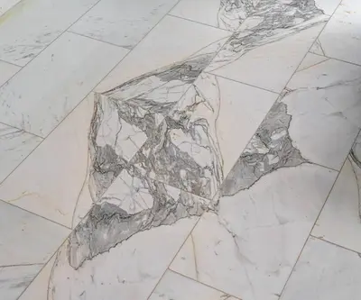 a white marble floor with a large rock on it at Luxury loft on the beach in Valencia