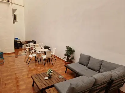 a living room with a couch and a table and chairs at Your Perfectt place in Valencia
