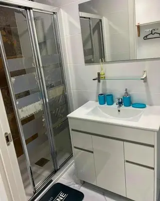 a white bathroom with a sink and a shower at Your Perfectt place in Valencia
