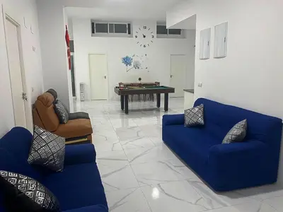 a living room with two blue couches and a table at Your Perfectt place in Valencia
