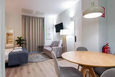 a living room with a table and a couch at VLC HOST - Reino in Valencia