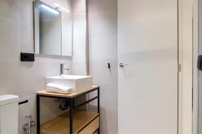 a bathroom with a sink and a mirror at VLC HOST - Reino in Valencia