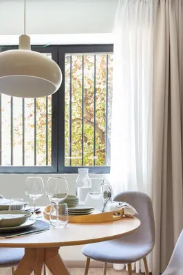 a dining room with a table and chairs and windows at VLC HOST - Reino in Valencia