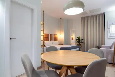 a living room with a table and chairs and a bedroom at VLC HOST - Reino in Valencia
