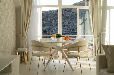 a dining room with a table and chairs in front of a window at Apartamento mar&menta in Cullera