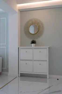 a white dresser in a white room with a mirror at Apartamento mar&menta in Cullera