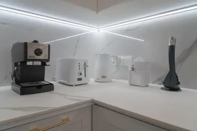 a kitchen counter with a coffee maker and appliances at Apartamento mar&menta in Cullera