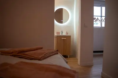 a bedroom with a bed and a sink and a mirror at La Siesta Hostel in Almarda
