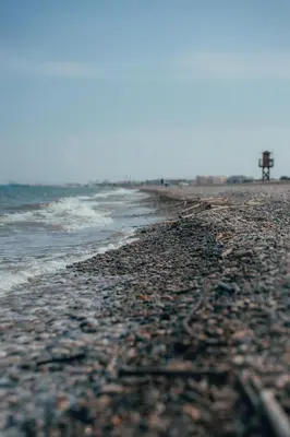 a beach with a rocky shoreline and the ocean at La Siesta Hostel in Almarda