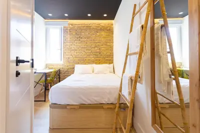 a bedroom with two bunk beds and a brick wall at Private room Beach Valencia in Valencia