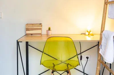 a yellow chair sitting in front of a desk at Private room Beach Valencia in Valencia
